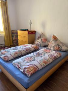a bed with four pillows on it in a room at Vorderer Westen Kassel in Kassel
