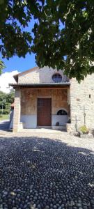a brick building with a garage with a brown door at Casa GALLI Como in Colverde