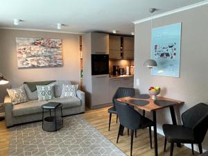a living room with a couch and a table at Mittendrin 102 in Sylt