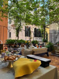 a table with a plate of food on a patio at B&B Beroni a Venezia in Venice