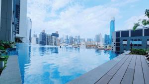 a swimming pool with a city skyline in the background at Skyline Luxury Suite KlCC &TRX View in Kuala Lumpur