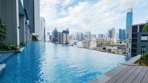 a swimming pool on the roof of a building with a city at Skyline Luxury Suite KlCC &TRX View in Kuala Lumpur
