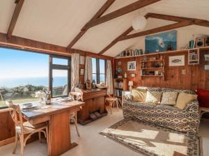 a living room with a table and a couch at The Cabin in Cawsand