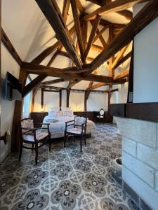 a bedroom with a bed and a tv in a room at Pavillon des communs in Bornel