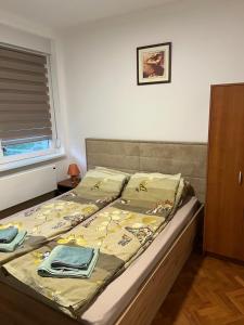 a bed with a blanket on it in a bedroom at Tim in Kalna
