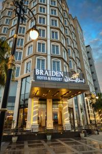 a building with a sign for a hotel at Braiden Hotel in Al Jubail
