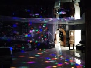 a nightclub with a view of a city at night at Готель Колізей in Khmelnytskyi