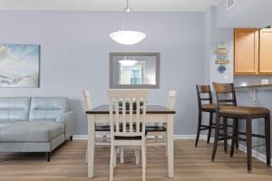 a kitchen and dining room with a table and chairs at 5 Star Resort 2BR 2 BATH King Suite Shuttle Pools Across from Beach 2208 in Destin