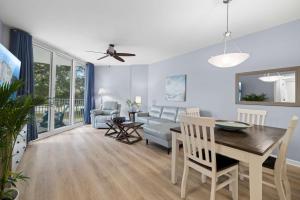 a dining room and living room with a table and chairs at 5 Star Resort 2BR 2 BATH King Suite Shuttle Pools Across from Beach 2208 in Destin