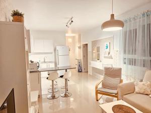 a kitchen and living room with a couch and a table at MyGuest Cornelius 70 , 1-Bedroom Luxury Apartment in Iskele