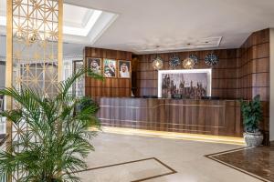 a lobby of a hotel with a reception desk at Braiden Hotel in Al Jubail