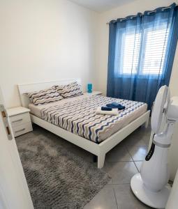 a bedroom with a bed with a blue curtain at Seaside in San Nicola Arcella! in Saracena +61 photos