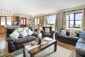 a living room with leather couches and a table at 4 Bed in Upton Cross oc-j34643 in Upton