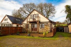 a small house with a porch and a fence at 4 Bed in Upton Cross oc-j34643 in Upton
