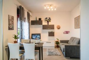 a living room with a table and a couch at Seaside in San Nicola Arcella! in Saracena