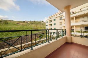 a balcony with a view of a building at Ocean Gardens Apartment by Mth in Caniço