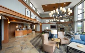 a lobby of a hotel with a fireplace at Holiday Inn Resort Lake George - Adirondack Area by IHG in Lake George