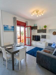 a living room with a table and a couch at Seaside in San Nicola Arcella! in Saracena