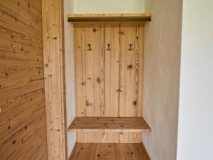 a wooden sauna with a wooden bench in a room at Panorama Suite am Marschbachhof in Walchsee