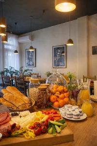 a table topped with lots of vegetables and other foods at Grand Boutique Hotel in Prishtinë