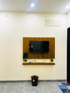 a flat screen tv on a wall in a room at Hotel G17 and Restaurant in Dhāmnod