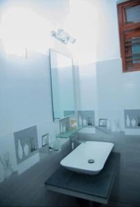 a bathroom with a white sink and a mirror at Green Shadow Inn in Galle +18 photos
