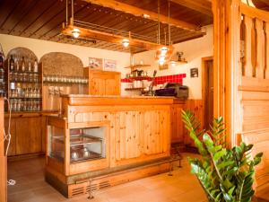 a kitchen with wooden cabinets and a bar at Dobersbergerhof in Dobersberg