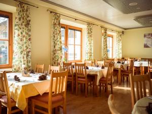 a dining room with tables and chairs and windows at Dobersbergerhof in Dobersberg