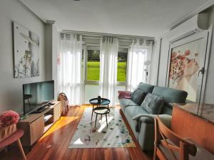 a living room with a couch and a tv at APARTAMENTO VALMAYOR in Potes