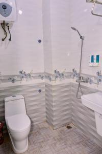 a bathroom with a toilet and a sink at Cat Ba Bay Vision Hotel in Cat Ba +55 photos