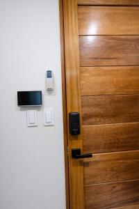 a wooden door with a television on top of it at studio confort in Iquitos +1 photo