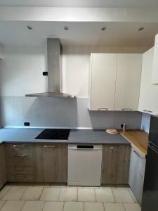 a kitchen with white cabinets and a stove top oven at Casa Camilla in Lido di Fermo