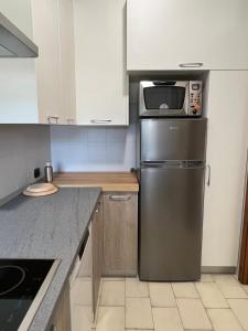 a kitchen with a stainless steel refrigerator and a microwave at Casa Camilla in Lido di Fermo