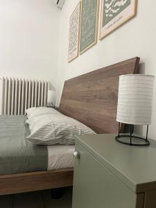 a bedroom with a bed and a table with a lamp at Casa Camilla in Lido di Fermo
