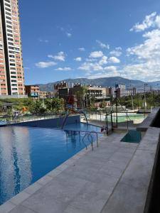 a swimming pool with a playground in a city at Apartamento Nogales in Bello