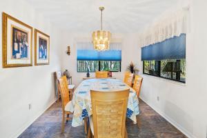 a dining room with a table and chairs at Sea Woods Home 4205 in New Smyrna Beach