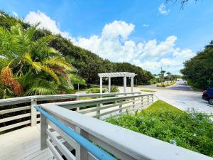 a white fence on a deck with a gazebo at Sea Woods Home 4205 in New Smyrna Beach