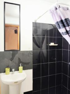 a bathroom with a sink and a mirror at Hospedaje Amore per il lago in Villarrica +43 photos