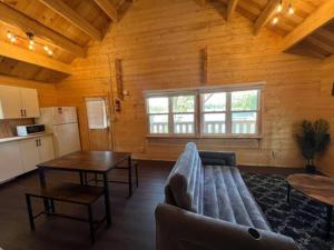a living room with a couch and a table at Horseshoe Lake Beachside Cottage in Parry Sound