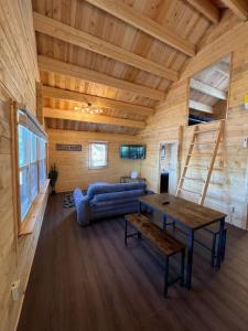 a living room with a couch and a table at Horseshoe Lake Beachside Cottage in Parry Sound