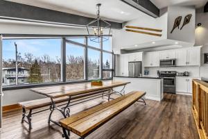 a kitchen with a wooden table and a large window at Mountain Trail-Smart TV-Self Check-In-Full Kitchen-Balcony-BBQ in Blue Mountains