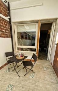 a patio with a table and chairs and a window at Da' Mi ' Nonni in Viareggio