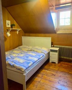 a bedroom with a bed and a window at Turistická Chata Pláně in Český Dub