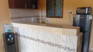 a kitchen with a counter top and a refrigerator at Breezes home Bamburi in Bamburi