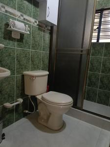 a bathroom with a toilet and a shower at Casa Campestre Arama in Paipa +14 photos