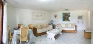 a living room with a couch and a table at Sardinia Re - Grecale 25 in Porto Rotondo