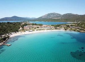 an aerial view of a beach with blue water at Sardinia Re - Grecale 25 in Porto Rotondo