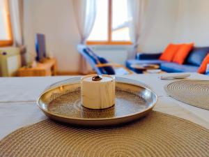 a candle sitting on a plate on a table at Panorama Sky Apartment -11 min by walk to Old Town - Free Parking in Sarajevo