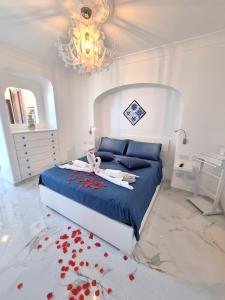 a bedroom with a bed with red hearts on the floor at Amalfi House Marlidia in Conca dei Marini