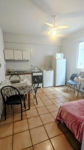 a kitchen with a table and a kitchen with a refrigerator at Apto Centro Floripa 03 in Florianópolis +12 photos